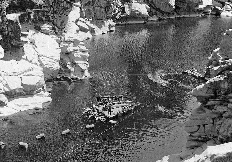Photo of river pool and the raft used for gold-dredging.